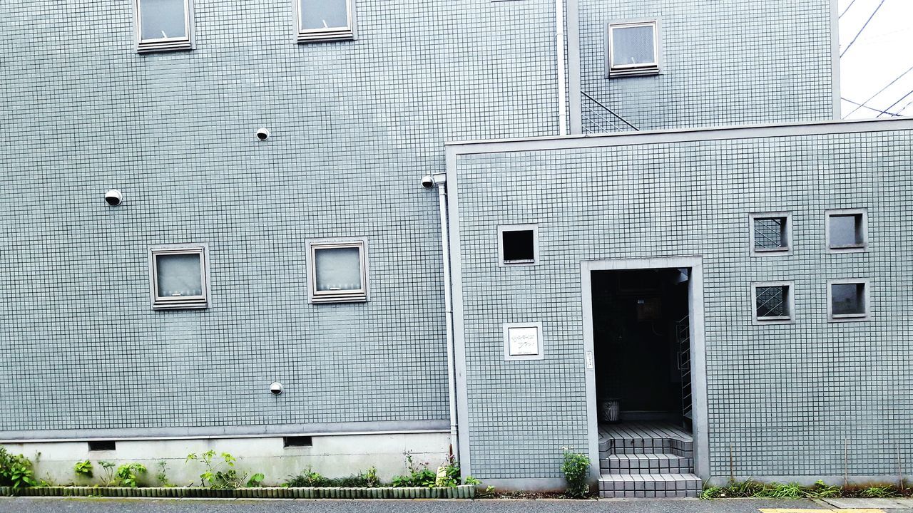 OPEN DOOR OF BUILDING WITH WINDOWS