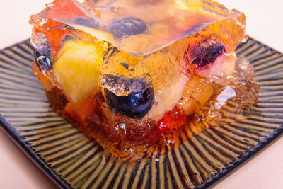 Jelly from different fruits and berries on a square saucer. dessert.
