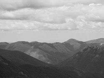 Scenic view of mountains against cloudy sky