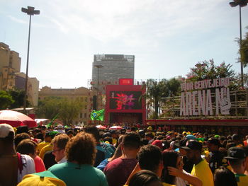 People on street in city against sky