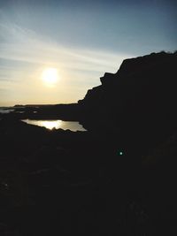 Scenic view of silhouette mountain against sky during sunset