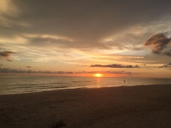 Scenic view of beach against sky during sunset