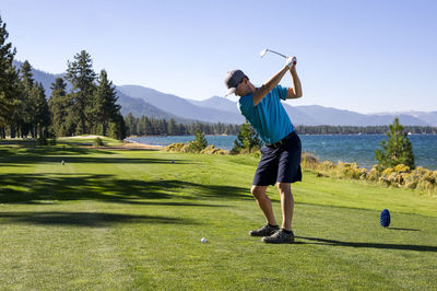 A man teeing off at edgewood tahoe in stateline, nevada.