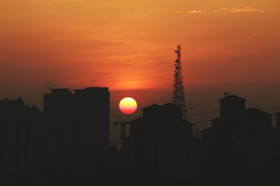 Silhouette of communications tower at sunset