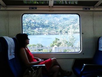 Rear view of people sitting in train
