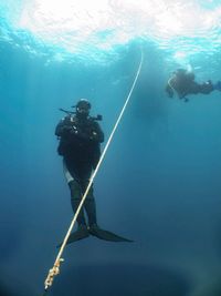 People scuba diving under sea