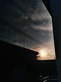 Reflection of silhouette building on glass window