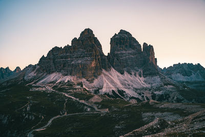 Rock formations against sky during sunset