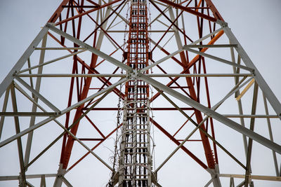 Low angle view of communications tower against sky