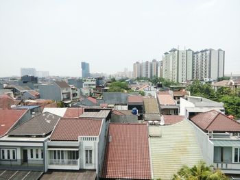 Buildings in city against clear sky