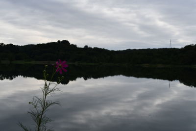 Scenic view of lake against cloudy sky