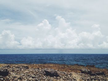 Scenic view of sea against cloudy sky