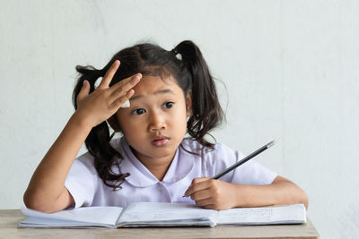 Cute girl studying at classroom