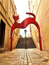 Low angle view of steps amidst buildings