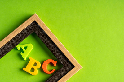 High angle view of toys on table against green background
