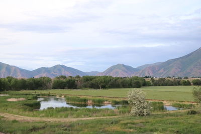 Scenic view of lake and mountains against sky