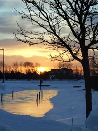 Scenic view of snow covered landscape at sunset