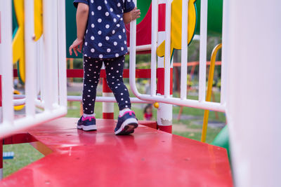 Low section of woman standing on playground
