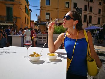 Woman eating in city