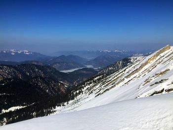 Scenic view of snowcapped mountain against blue sky