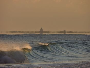 Scenic view of sea against clear sky during sunset