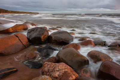 Rocks in sea against sky