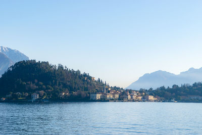 Scenic view of lake by mountains against clear sky