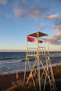 Lifeguard hut on beach against sky