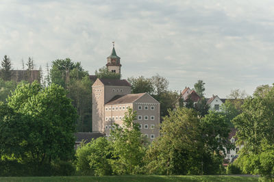 Trees and buildings against sky