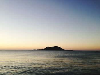 Scenic view of sea against clear sky during sunset