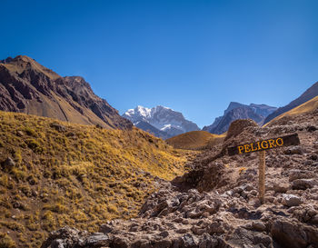 Scenic view of mountains against clear blue sky