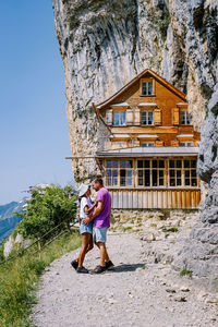 Full length of a woman with building against mountain