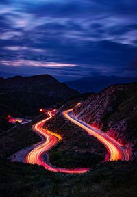 High angle view of light trails on road against sky at night