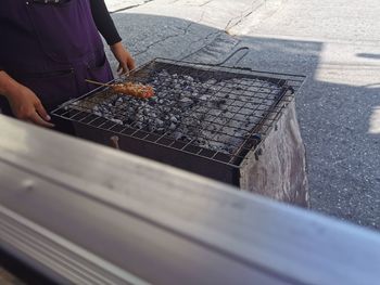 Man preparing food on barbecue grill