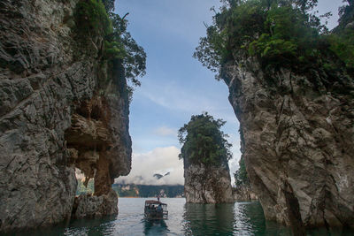 Scenic view of rocks in sea against sky