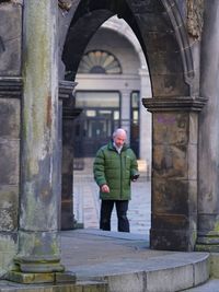 Full length of man standing at historic building