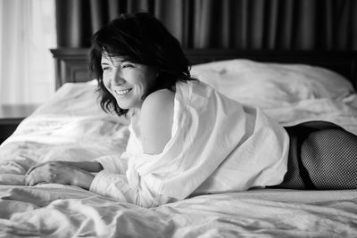 Young woman lying on bed at home