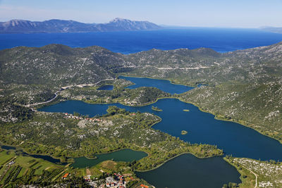 High angle view of sea and bay against sky