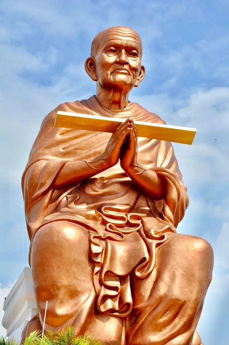 LOW ANGLE VIEW OF STATUE OF BUDDHA