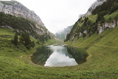 Scenic view of waterfall against sky