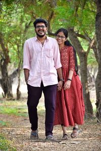 Full length of couple standing on field