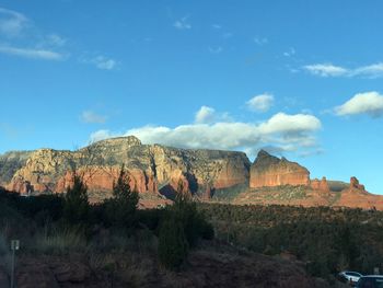 Rock formations on landscape against blue sky