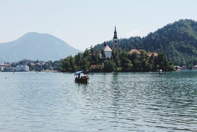 Scenic and picturesque view of lake bled, surrounded by mountains and forests. 