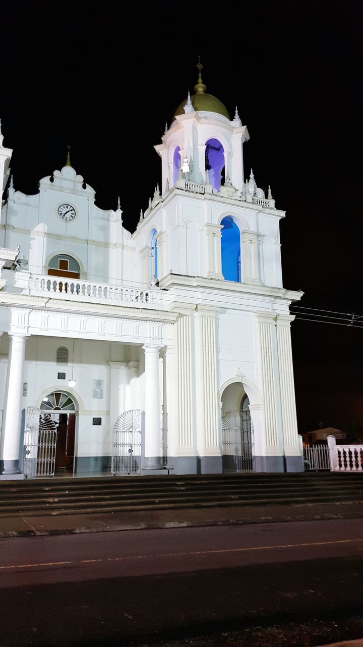 religion, church, place of worship, architecture, built structure, building exterior, spirituality, night, illuminated, low angle view, cathedral, cross, sky, arch, clear sky, facade, outdoors, lighting equipment