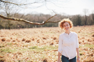 Portrait of woman standing on field