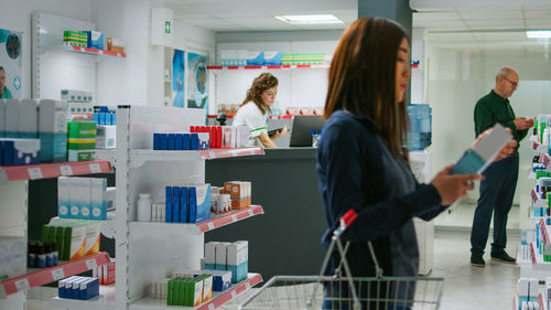 Rear view of woman standing in store