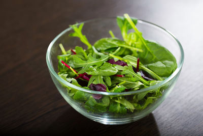 A fresh mixed salad on a wooden table. a notion of a useful and healthy meals