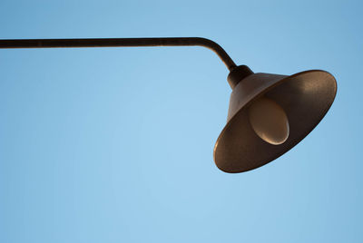 Low angle view of lamp against clear blue sky