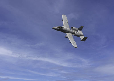 Low angle view of airplane flying in sky