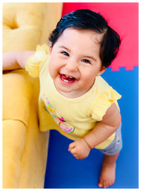 Portrait of cute smiling baby girl at home
